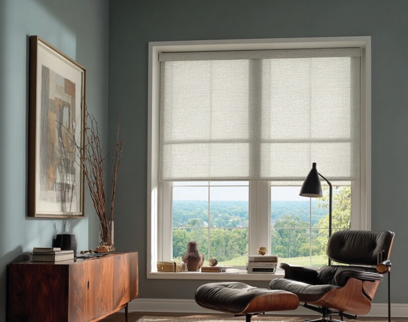 Wide window dressed with a warm white Roman shade, providing smooth, tailored light filtering.