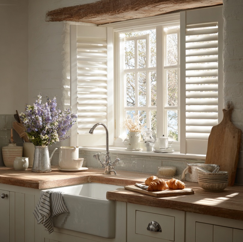 Kitchen window with plantation-style shutters filtering natural light in a Fullerton, CA home