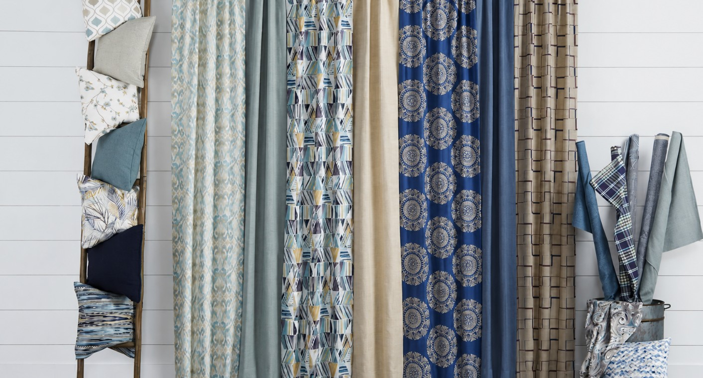 Designer fabric swatches and custom drapery materials displayed in a window treatment showroom. This image is AI-generated and intended for inspirational purposes only; it may not be completely accurate.